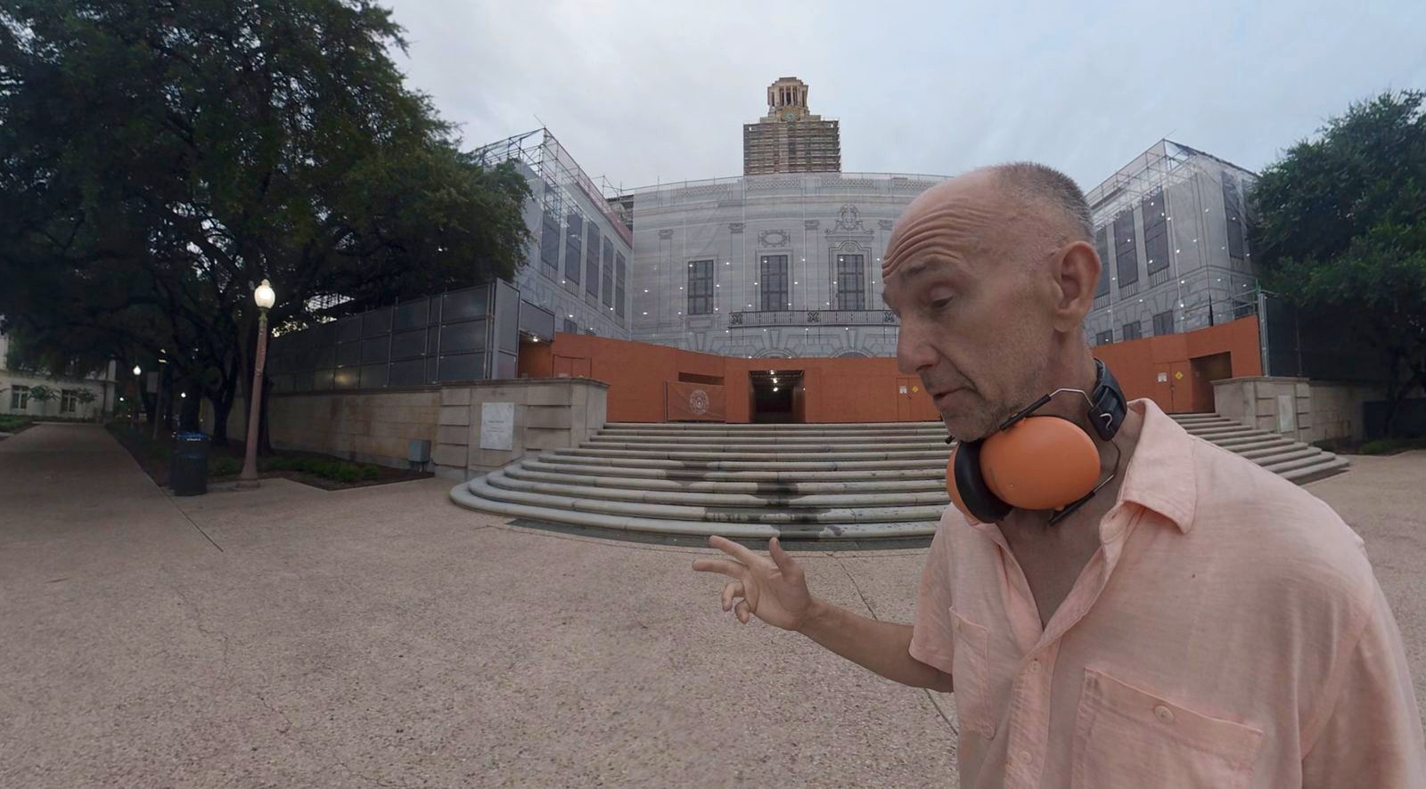 Arthur Brent Porter standing in front of the University of Texas at Austin Main Building Tower, currently under scaffolding